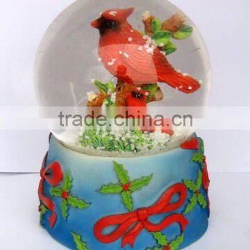 red bird snow globe