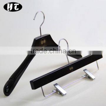 bright black high end wooden clothing hanger and pants hanger