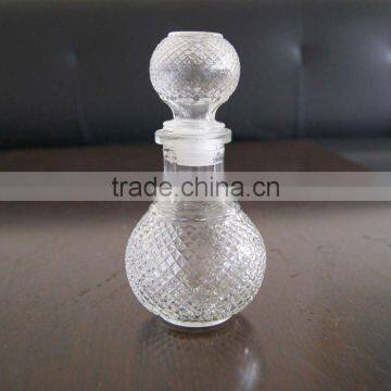 clear round glass wine bottle