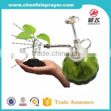 Green glass botthe with garden sprayer for plant sprayer