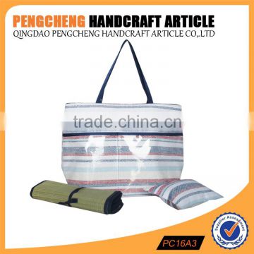 Paper straw material beach bag containing the mat and pillow