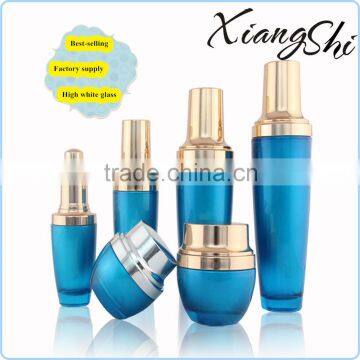 sky blue cream and lotion glass cosmetic bottles set with gold sprayer