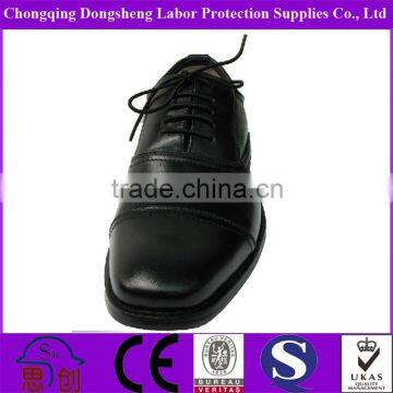 black officer working leather shoe