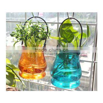 colored and transparent candle holder with metal ifting rope ourtdoor water vase handing