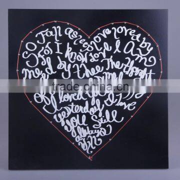 hanging wall art with the string art and the paint