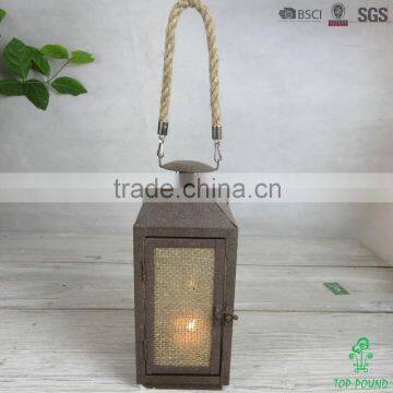 square rusty metal lantern with jute cloth and jute rope for candle