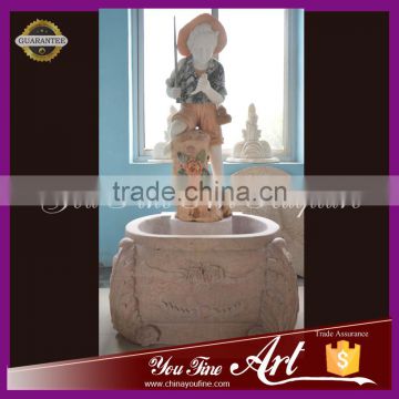 hand carved nature stone fountain with little boy