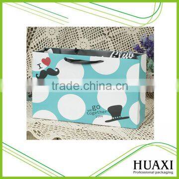 Recyclable paper bag with ribbon handle