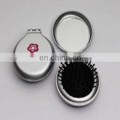 Folding hairbrush with mirror