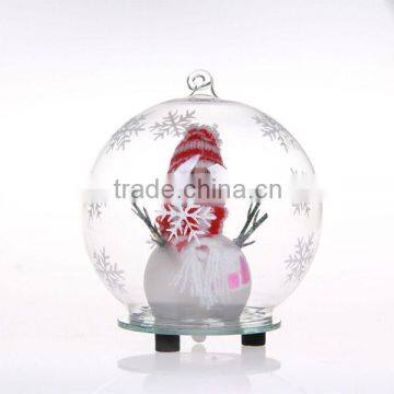 clear glass ball with snow man wear scarf inside