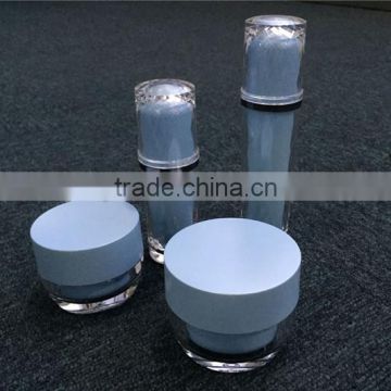 Shiny blue plastic creme jars with screw cap and bottles