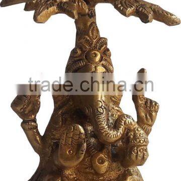 brass ganesha under tree