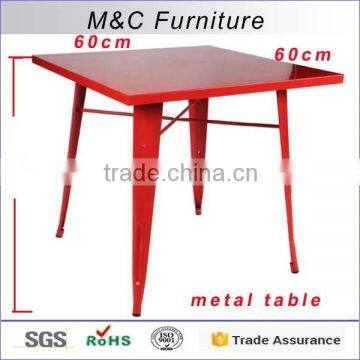 Small red square folding metal table with four legs