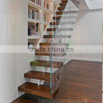 floating staircase with teak treads and frameless glass railing stairway