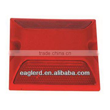 Red plastic road studs with double reflectors