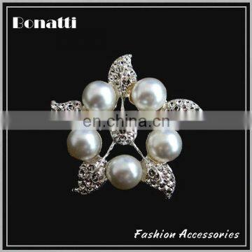 metal brooch with pearl