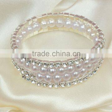 Four rows crystal and rhinestone graduated wraparound coil bracelet