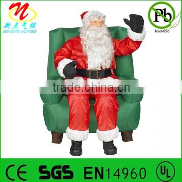 Inflatable animated Santa Claus sitting on chair for Christmas decorations