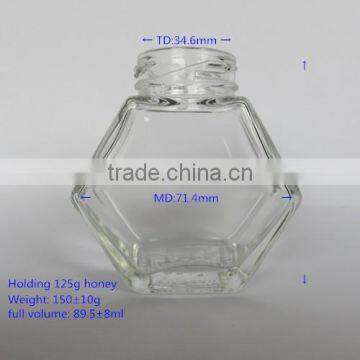 holding 125g Honey glass jar