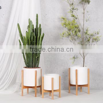 walnut stand with smooth matte pot fibreglass planter pot