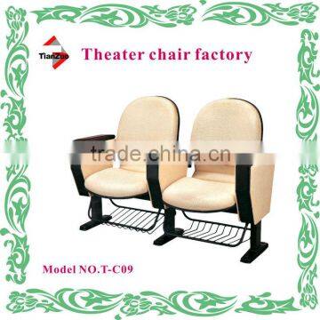 Immovable school auditorium chairs with bookshelf and writing pad