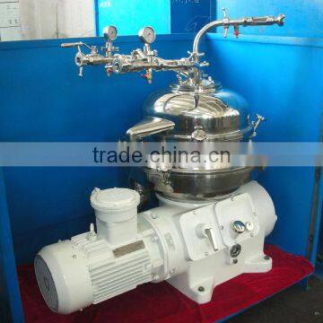 Two phase centrifuge/disc type oil water separator