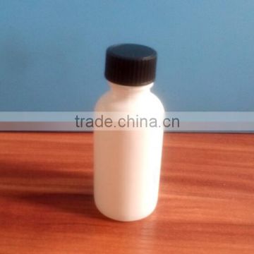 1 oz white boston round bottle with black screw cap