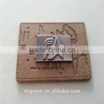 Embossed leather patch with metal logo for lady's handbag