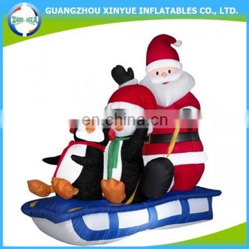 Hot selling inflatable penguin christmas with santa on sleign