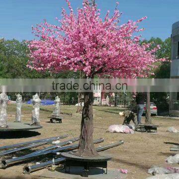 Pink artificial cherry blossom trees with rotating base