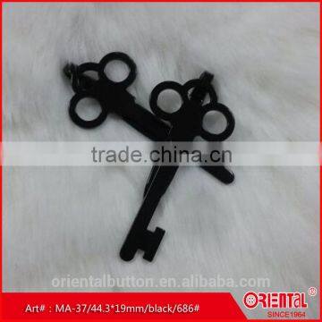 matt black key-shaped metal brooch for men