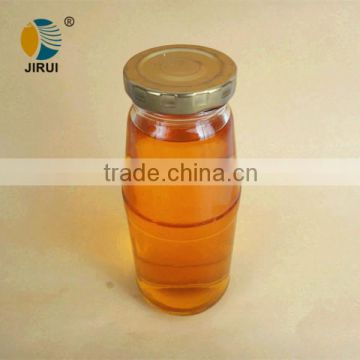 clear glass fruit juice bottle