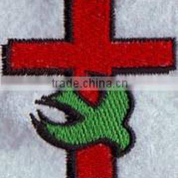 Customized cross logo embroidered patches with plastic backing for bags.