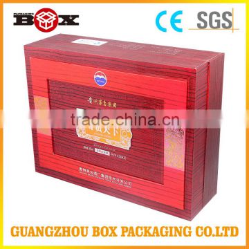 Red paper package box with yellow satin