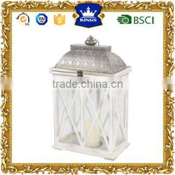 White wooden lantern with metal top and LED candle