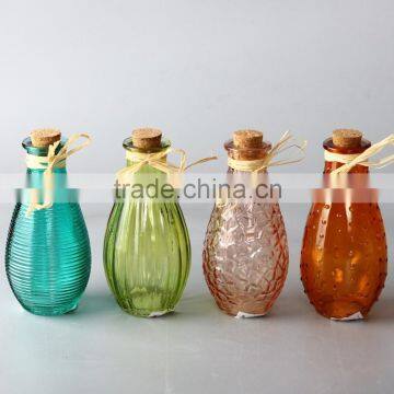 small glass bottle with cork and raffia with four styles