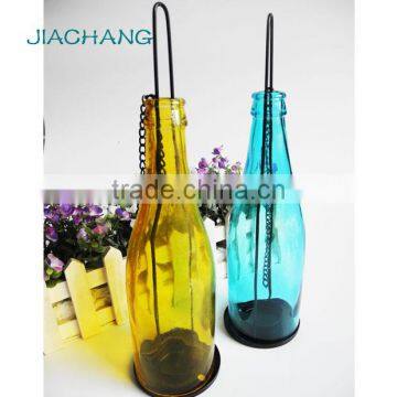 Scented candle in colored glass jar hanging bottle