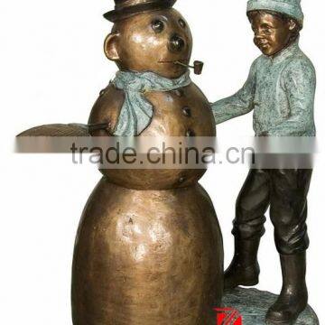 Bronze boy making snowman statues for garden