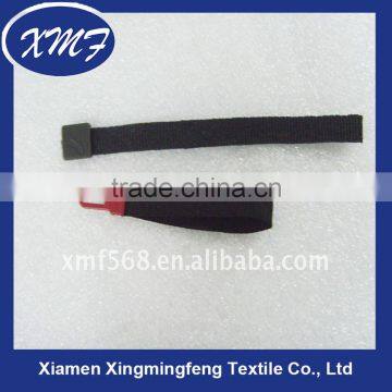 Plastic injection zipper pull with woven tape