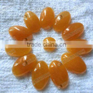 Dyed orange jade oval cabochon for jewelry setting