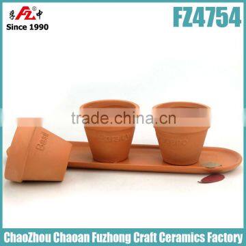 Small and round terracotta planter with saucer