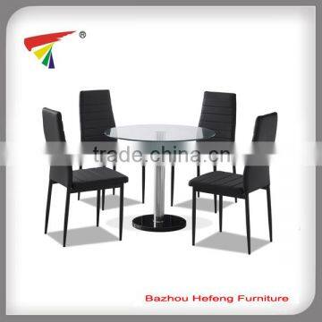 Modern round glass dining table with black PVC chair