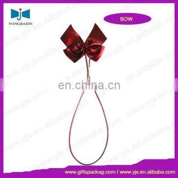 Red ribbon pre-tied bow with loop for gift packaging