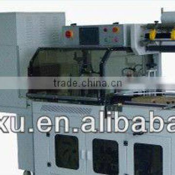 Shrink wrapping machine
