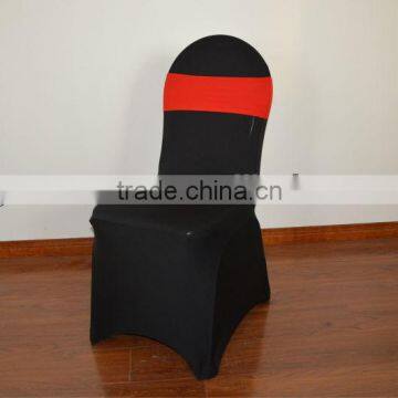 Black lycra chair cover with red spandex sash for weddings