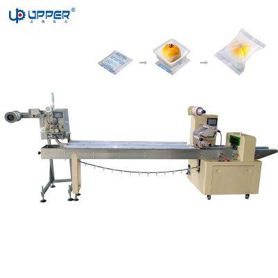 Flow packaging machine with pouch dispenser