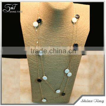 long gold plated chain necklace with white and black enamel round beads embelishing costume jewelry