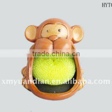 monkey design holder with yellow dish-cleaning sponge