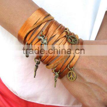 sliced leather bracelet, wide Leather Cuff - Charms Bracelet, Multi Strap Bracelet with peace and gun charms