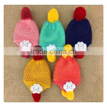 Popular style earflaps hat with ball top ,with flower decoration winter caps for kids